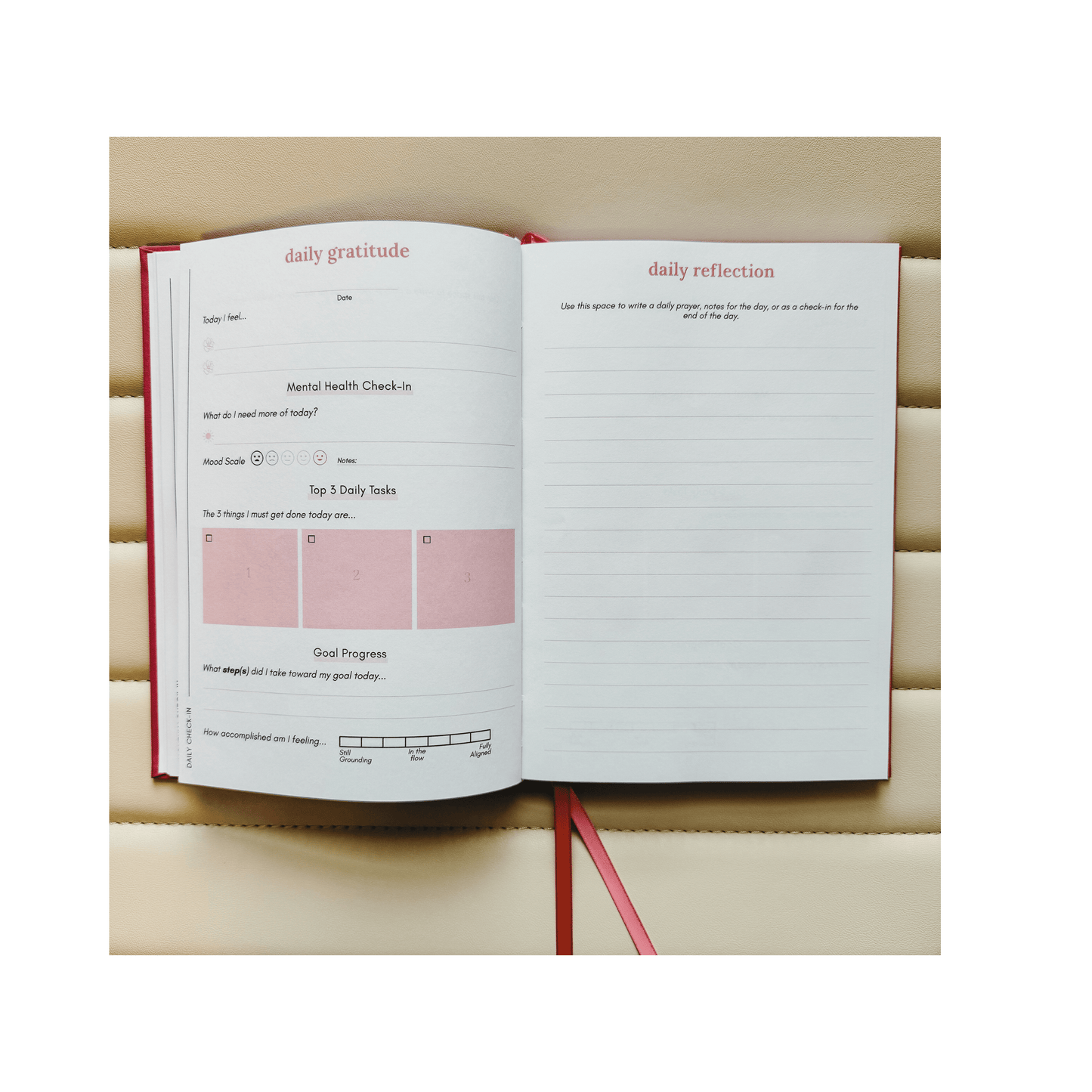 Open journal with daily reflection and gratitude prompts on a wooden surface