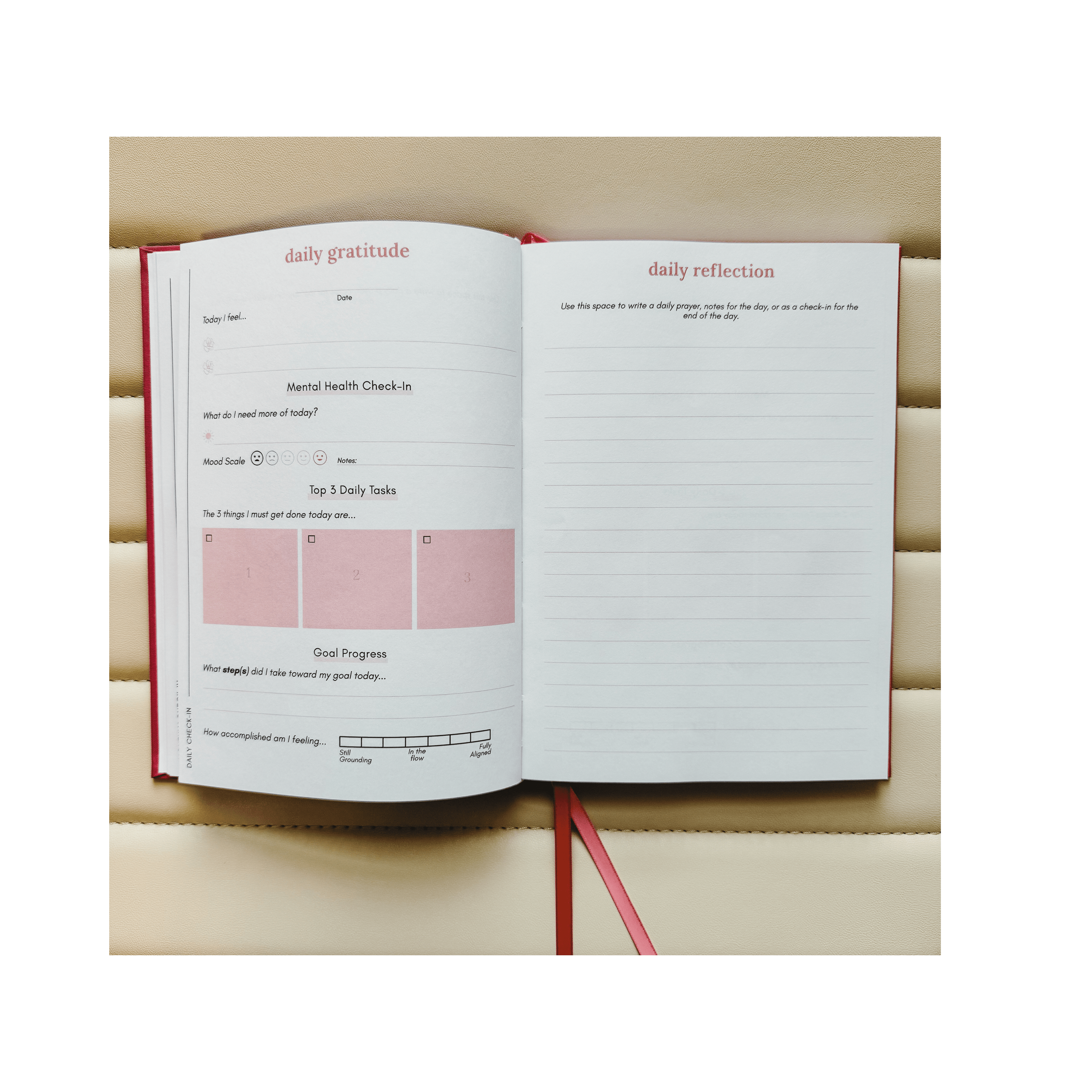 Open journal with daily reflection and gratitude prompts on a wooden surface