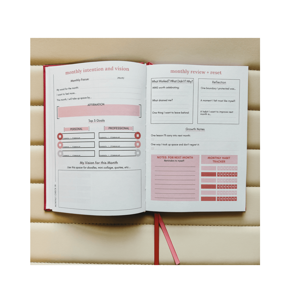 Open planner with monthly intention and vision sections on a wooden surface
